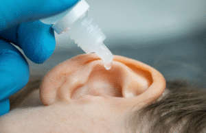 Ear drops being applied to help with dry skin in ears