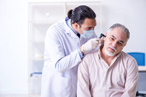 Doctor examining a patient with ear ache