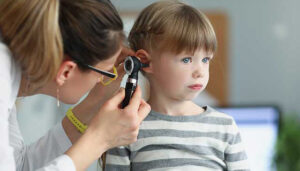 Child with acute otitis media experiencing ear pain