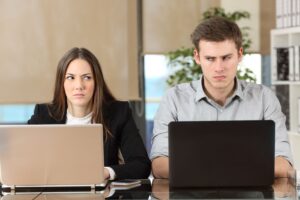 Frustrated employee experiencing a toxic work environment at office desk