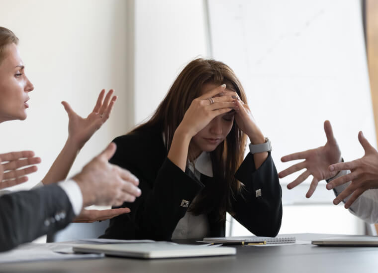 Frustrated employee experiencing a toxic work environment at office desk