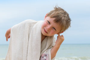 Home remedy for water-clogged ear using gravity drainage