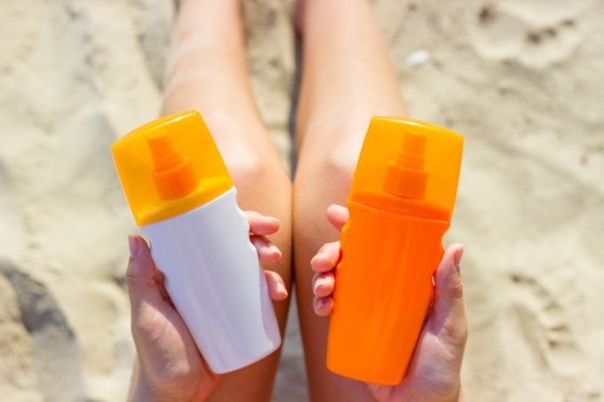 Two bottles labeled sunscreen and sunblock side by side